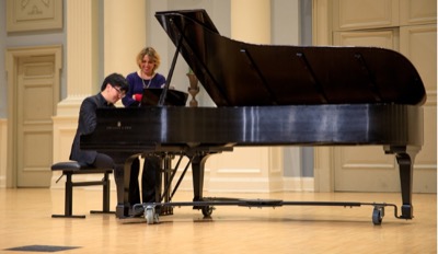 students play on a grand piano