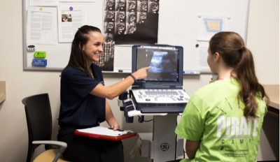two student examine medical machine